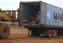 Scrap Company Turns to Illegal Timber Trafficking An earthmover uploads timber